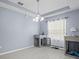 Dining room features light gray floors, neutral walls, and a modern chandelier at 6273 Pinehurst Dr, Spring Hill, FL 34606