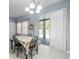 Dining room with a view of the pool area through sliding glass doors, with matching table and chairs at 6273 Pinehurst Dr, Spring Hill, FL 34606