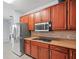 Modern kitchen boasts stainless steel appliances and stylish backsplash at 6273 Pinehurst Dr, Spring Hill, FL 34606