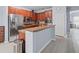 Well-equipped kitchen features stainless steel appliances and a breakfast bar at 6273 Pinehurst Dr, Spring Hill, FL 34606