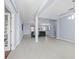 Spacious living room with light gray flooring open to the kitchen at 6273 Pinehurst Dr, Spring Hill, FL 34606