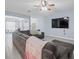 Spacious living room with wood floors, a sectional sofa, and a flatscreen television at 6273 Pinehurst Dr, Spring Hill, FL 34606