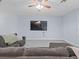 Open living room features wood floors, ceiling fan, and mounted flatscreen television at 6273 Pinehurst Dr, Spring Hill, FL 34606