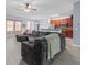 Open concept living room features a ceiling fan, wood floors, and modern kitchen at 6273 Pinehurst Dr, Spring Hill, FL 34606