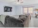 Open living room with a large sectional sofa and a mounted flatscreen television at 6273 Pinehurst Dr, Spring Hill, FL 34606