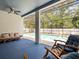 Enclosed patio with a pool and outdoor seating at 6273 Pinehurst Dr, Spring Hill, FL 34606