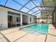 Enjoy the screened-in pool, with an attached patio and a beautiful sunbathing area at 6273 Pinehurst Dr, Spring Hill, FL 34606