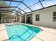 An expansive, screened-in pool beckons for hours of Gathering fun in the Florida sunshine at 6273 Pinehurst Dr, Spring Hill, FL 34606
