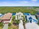 Waterfront home featuring lush tropical landscaping, open floor plan, balcony, and views of the mangroves and ocean at 6321 Garland Ct, New Port Richey, FL 34652