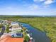 Breathtaking aerial view of waterfront homes with private docks along a tranquil river leading to the expansive ocean horizon at 6321 Garland Ct, New Port Richey, FL 34652