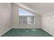 Bright attic room with a unique window, closet and green carpet at 6321 Garland Ct, New Port Richey, FL 34652