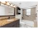 Updated bathroom features vanity with granite top and combination tub and shower with modern finishes at 6321 Garland Ct, New Port Richey, FL 34652