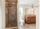 Tiled shower with glass door, vanity with granite, wood look flooring & modern finishes at 6321 Garland Ct, New Port Richey, FL 34652