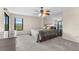 This bedroom is well-lit and features a ceiling fan, a large window, and ample closet space at 6321 Garland Ct, New Port Richey, FL 34652