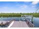 Dock with lift overlooking the waterfront at 6321 Garland Ct, New Port Richey, FL 34652