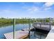 Picturesque waterfront dock with boat lift access, offering serene views and direct waterway access for boating and recreation at 6321 Garland Ct, New Port Richey, FL 34652