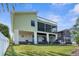 Two-story home showcasing a large screened porch and lush green lawn at 6321 Garland Ct, New Port Richey, FL 34652