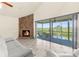Bright living room with vaulted ceilings, tile flooring, stone fireplace, and sliding glass doors to the lanai at 6321 Garland Ct, New Port Richey, FL 34652