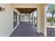 Inviting covered patio with wood flooring and waterfront view at 6321 Garland Ct, New Port Richey, FL 34652