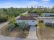 Aerial view of a two-story home featuring a long driveway and mature landscaping at 6440 Curtiss Ln, Spring Hill, FL 34609