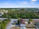 Lovely aerial view of a home nestled among trees with a fenced backyard and a glimpse of the surrounding community at 6440 Curtiss Ln, Spring Hill, FL 34609