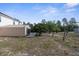 Backyard showing the shed and limited grassy area, backed by dense trees at 6440 Curtiss Ln, Spring Hill, FL 34609