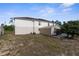 Backyard featuring a shed, partial grass, and the home's rear exterior at 6440 Curtiss Ln, Spring Hill, FL 34609