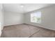 Bright and spacious bedroom with large window, ceiling fan, and plush carpet at 6440 Curtiss Ln, Spring Hill, FL 34609