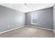 Neutral bedroom featuring a ceiling fan and window allowing natural light at 6440 Curtiss Ln, Spring Hill, FL 34609