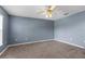Spacious bedroom featuring a ceiling fan and neutral carpet offers a comfortable retreat at 6440 Curtiss Ln, Spring Hill, FL 34609