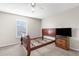 Neutral bedroom features a ceiling fan and a window allowing natural light at 6440 Curtiss Ln, Spring Hill, FL 34609