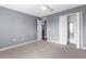 Bedroom with a walk-in closet, neutral carpet and walls, and a ceiling fan at 6440 Curtiss Ln, Spring Hill, FL 34609
