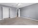Bedroom with a ceiling fan and a closet, neutral carpet and walls at 6440 Curtiss Ln, Spring Hill, FL 34609