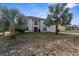 Charming two-story home with a well-maintained front yard and a red front door at 6440 Curtiss Ln, Spring Hill, FL 34609