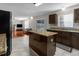 Kitchen with granite countertops, stainless appliances, a center island, and dark wood cabinets at 6440 Curtiss Ln, Spring Hill, FL 34609