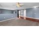 Open-concept living area with carpet and hardwood floors and high ceilings at 6440 Curtiss Ln, Spring Hill, FL 34609