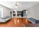 Open-concept living room showcasing hardwood floors and seamless flow into the modern kitchen at 6440 Curtiss Ln, Spring Hill, FL 34609