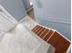 A high-angle view of the entryway staircase, featuring tile and carpeted steps at 6440 Curtiss Ln, Spring Hill, FL 34609