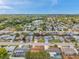 This aerial view highlights the neighborhood layout featuring a small lake and well-spaced homes with greenery at 7035 Cutty Sark Dr, Port Richey, FL 34668