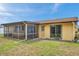 Backyard featuring a screened-in lanai and access to the home's interior at 7035 Cutty Sark Dr, Port Richey, FL 34668