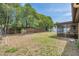 Large backyard featuring a screened lanai and mature trees for shade at 7035 Cutty Sark Dr, Port Richey, FL 34668