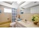 Bathroom with a yellow bathtub, patterned shower curtain, and a vanity with sink and countertop at 7035 Cutty Sark Dr, Port Richey, FL 34668