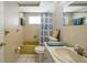Bathroom featuring a yellow bathtub, patterned shower curtain, vanity with sink, and white tile flooring at 7035 Cutty Sark Dr, Port Richey, FL 34668