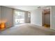 Cozy bedroom with neutral carpet, sliding glass door to backyard, and closet access at 7035 Cutty Sark Dr, Port Richey, FL 34668