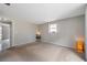 Bright bedroom with neutral carpet, large window, and ample space at 7035 Cutty Sark Dr, Port Richey, FL 34668