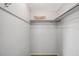 A closet with white walls, a shelf with a pillow, and a metal rod for hanging clothes at 7035 Cutty Sark Dr, Port Richey, FL 34668
