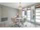 Stylish dining room with a chandelier and mirrored windows, offering an elegant space for gatherings at 7035 Cutty Sark Dr, Port Richey, FL 34668