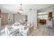Open-concept dining area with a chandelier, adjacent to the living area and a glimpse of the kitchen at 7035 Cutty Sark Dr, Port Richey, FL 34668
