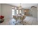 Charming dining area showcases a chandelier, mirrored windows, and a neatly set table with white linens at 7035 Cutty Sark Dr, Port Richey, FL 34668