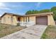 Charming one-story home with a stucco finish, attached garage, and a paved driveway at 7035 Cutty Sark Dr, Port Richey, FL 34668